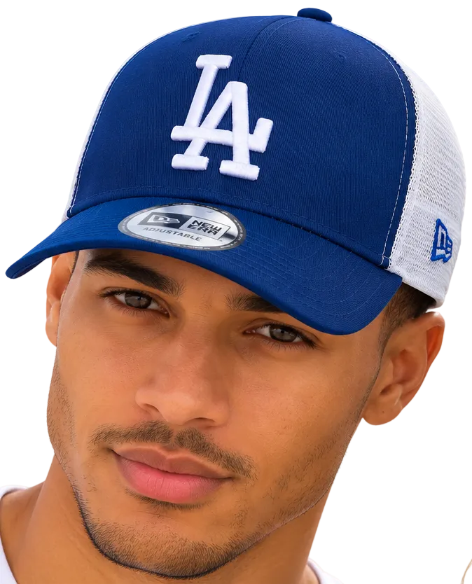 A close-up of a man wearing a blue and white Los Angeles Dodgers trucker hat with a New Era 9FIFTY sticker on the brim, set against a bright blue sky background.