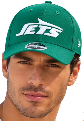 A man wearing matching green New York Jets baseball caps with white 'JETS' logos, photographed against a clear blue sky.
