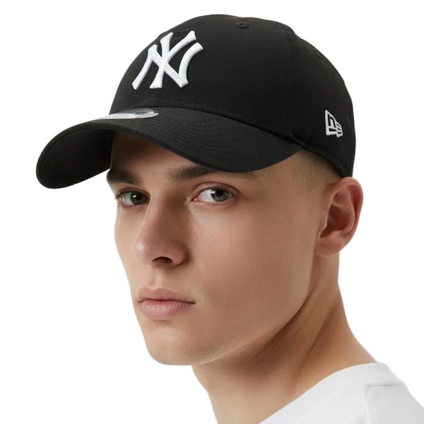 Person wearing a black cap with a logo on a white background
