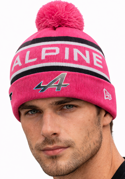 Man wearing a pink beanie with 'Alpine' branding on a white background