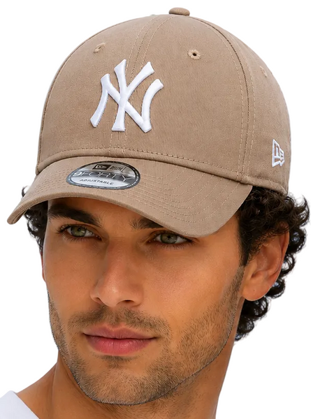 A man wearing matching tan New York Yankees baseball caps with white embroidered logos, posed against a light blue background.