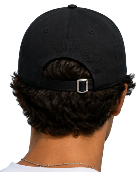  people shown from behind wearing black baseball caps with adjustable back straps and silver metal buckles, set against a clear blue sky.