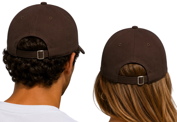Two people seen from behind wearing matching dark brown baseball caps with adjustable straps, set against a bright blue sky with light clouds.
