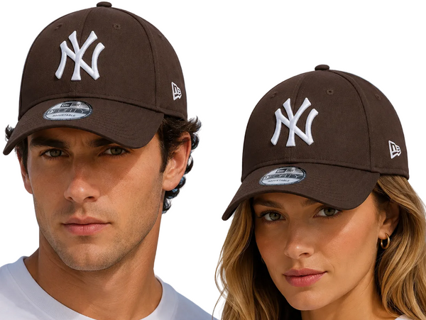 A man and a woman wearing dark brown New Era 9FORTY baseball caps with a white New York Yankees logo, set against a bright blue sky background.