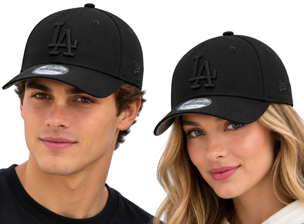 Two models wearing black Los Angeles Dodgers baseball caps with tonal embroidery, set against a bright blue sky background.