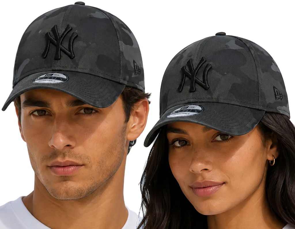 A man and a woman wearing matching dark gray New York Yankees baseball caps with a subtle tonal camouflage pattern and black embroidered logos, set against a light blue sky background.