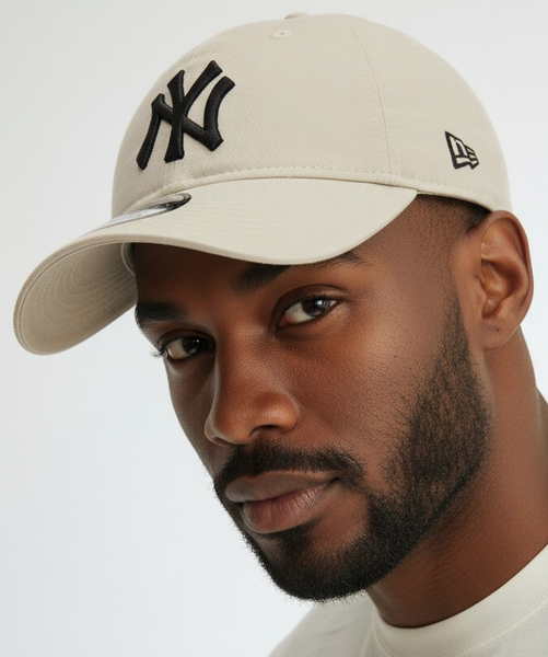 Man wearing a beige cap with an NY  logo 