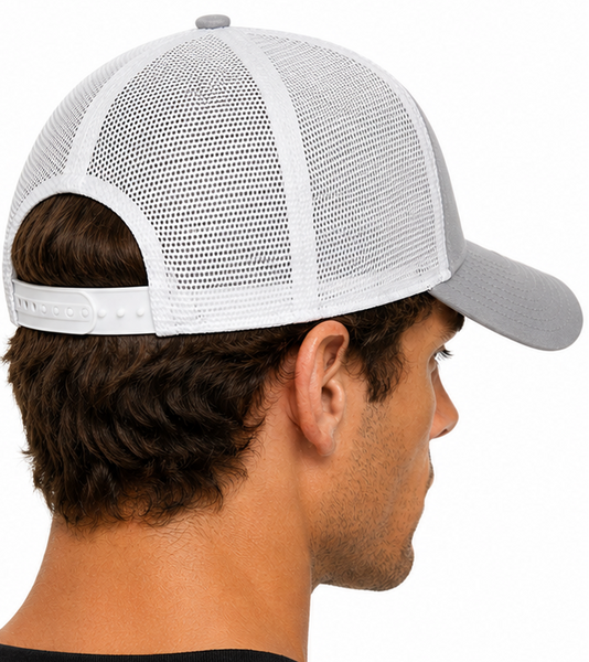 A man shown in profile wearing a light gray and white trucker-style baseball cap with a mesh back, photographed against a plain white background.